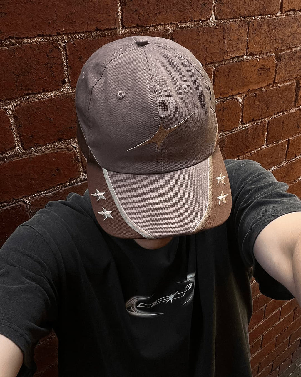 Person wearing brown Wheat Gold Star contrast cap