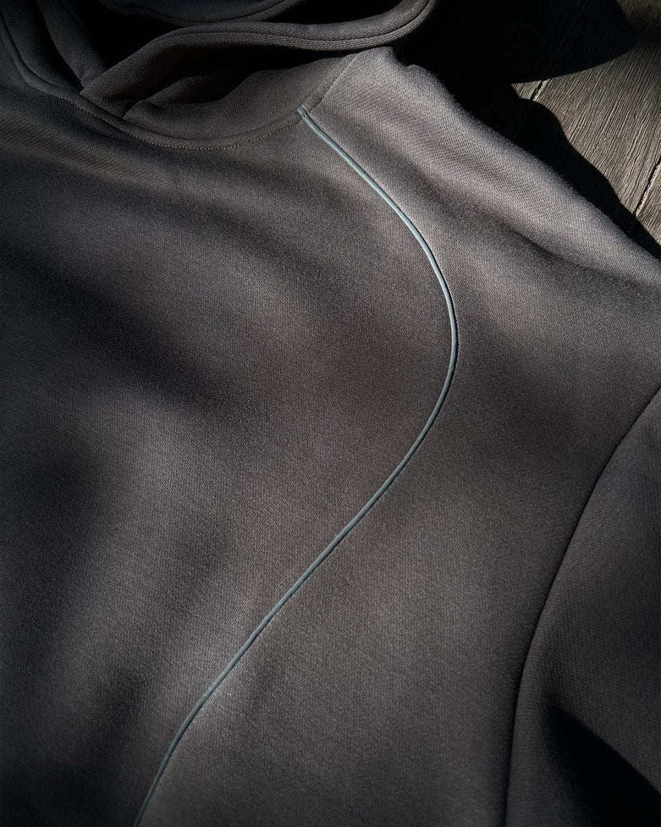 Close-up of reflective accent seam on charcoal hoodie