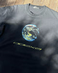 Washed black vintage tee with earth graphic and yellow ODEXA text, flat lay