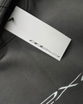 Close-up of grey hoodie with white ODEXA logo and hang tag