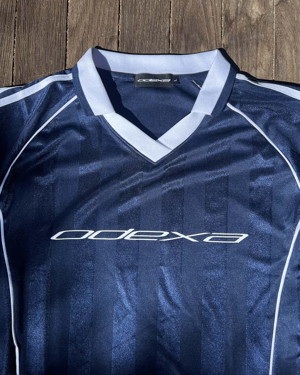 Navy striped football jersey with white ODEXA logo and V-neck collar, flat lay