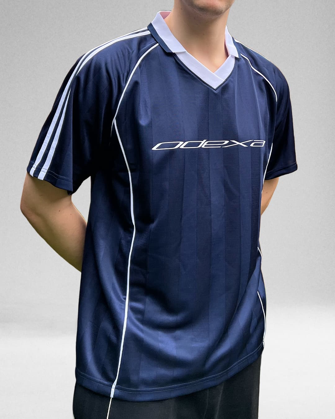 Model wearing navy ODEXA 1 jersey, front view