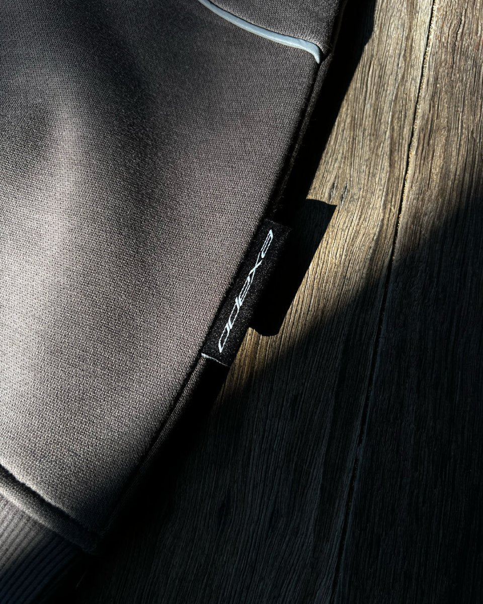 Close-up of charcoal hoodie fabric and ODEXA label