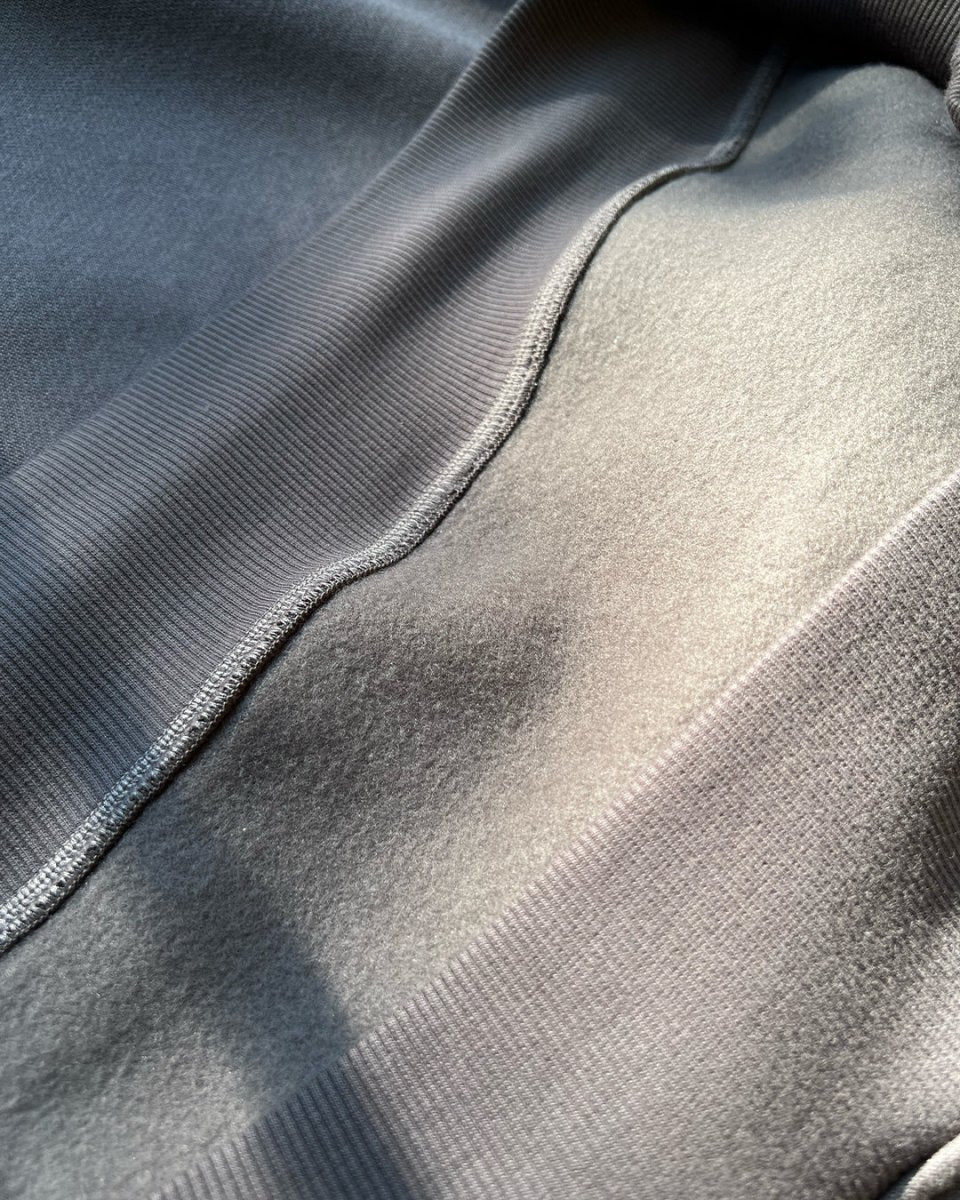 Close-up of reflective piping on charcoal hoodie