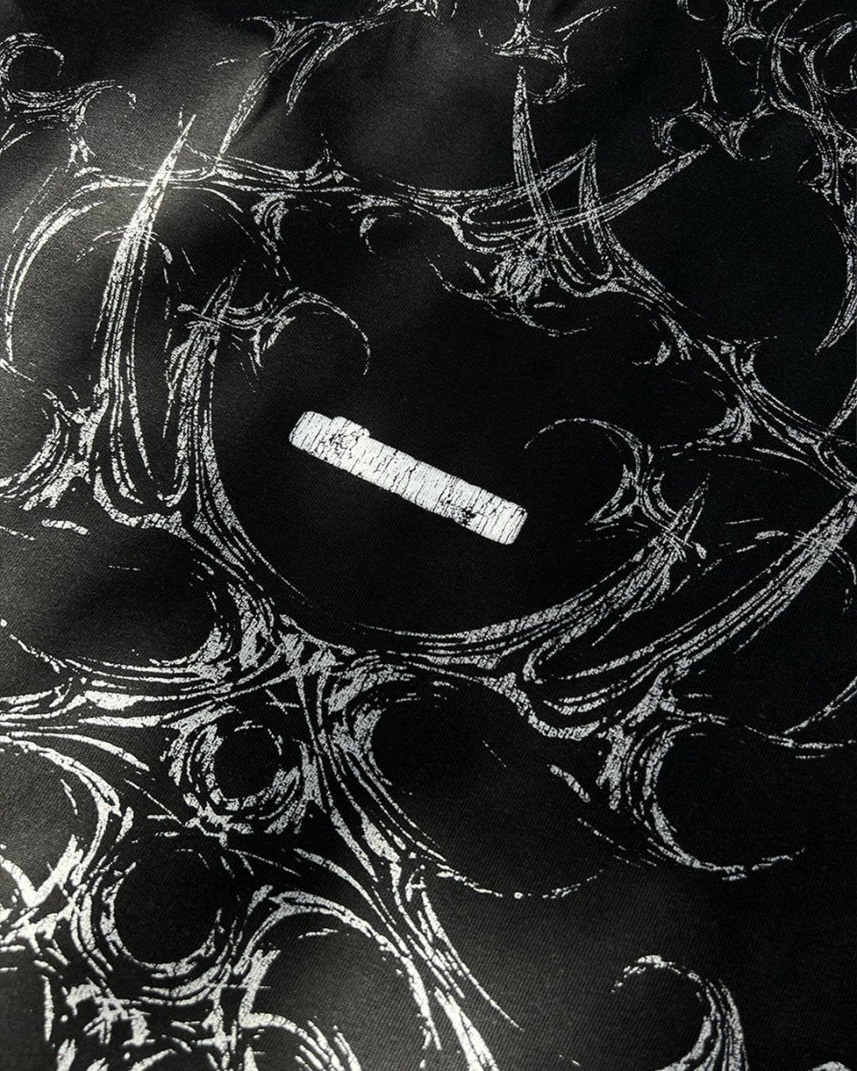 Close-up of white tribal bone back print on black tee