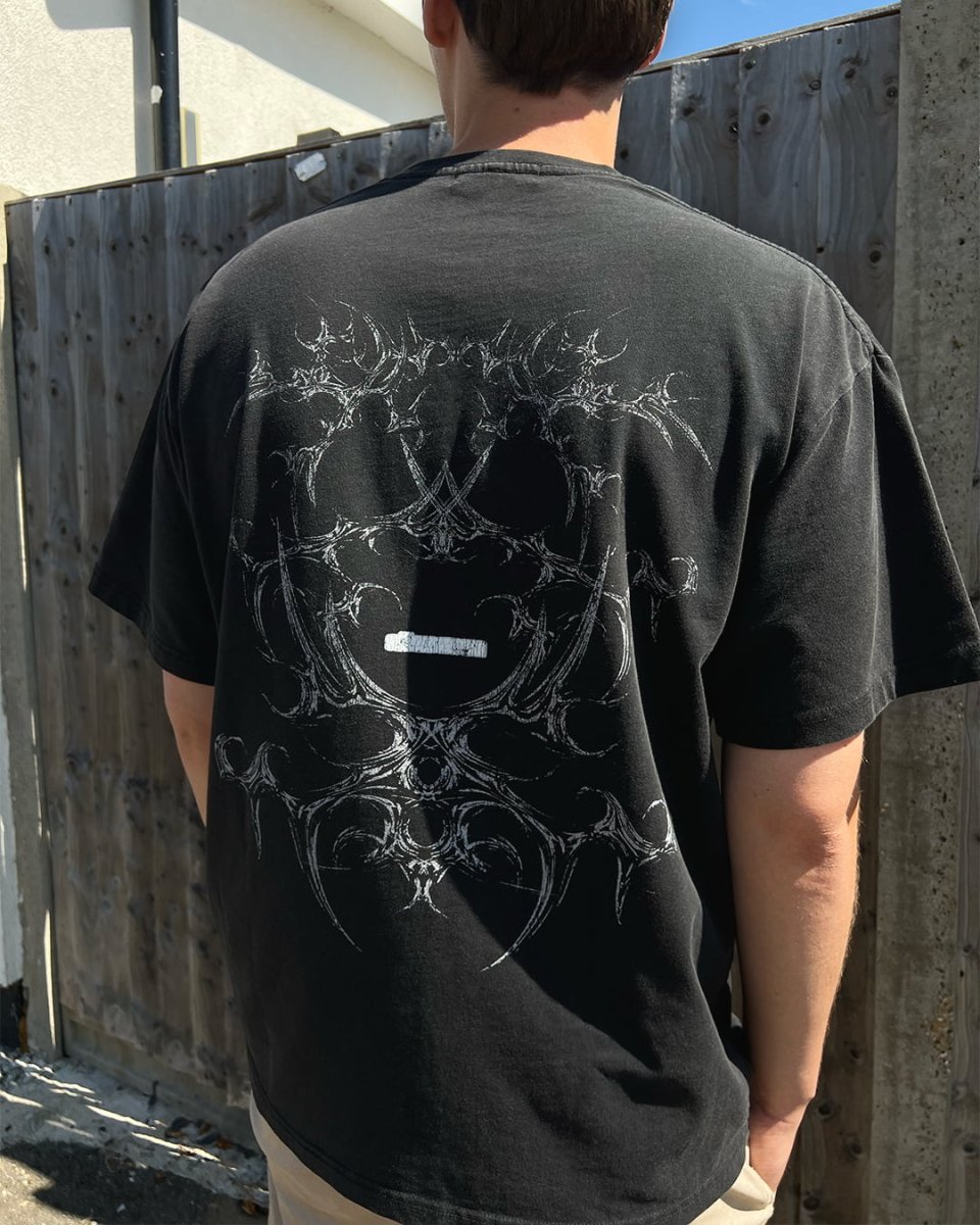 Model wearing Black Bone vintage tee, back view with tribal bone print
