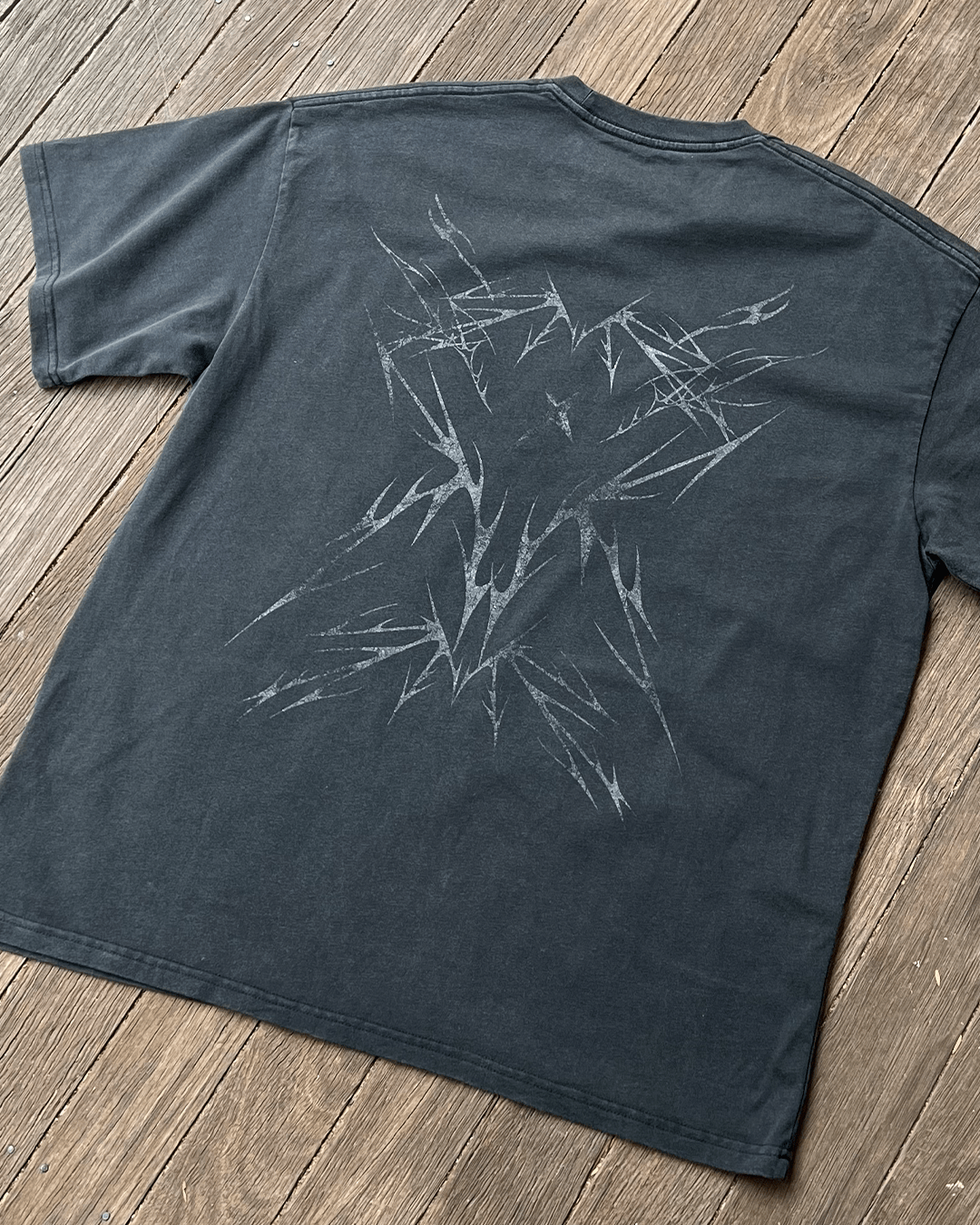 Sharp Black vintage tee tribal back print, angled flat lay