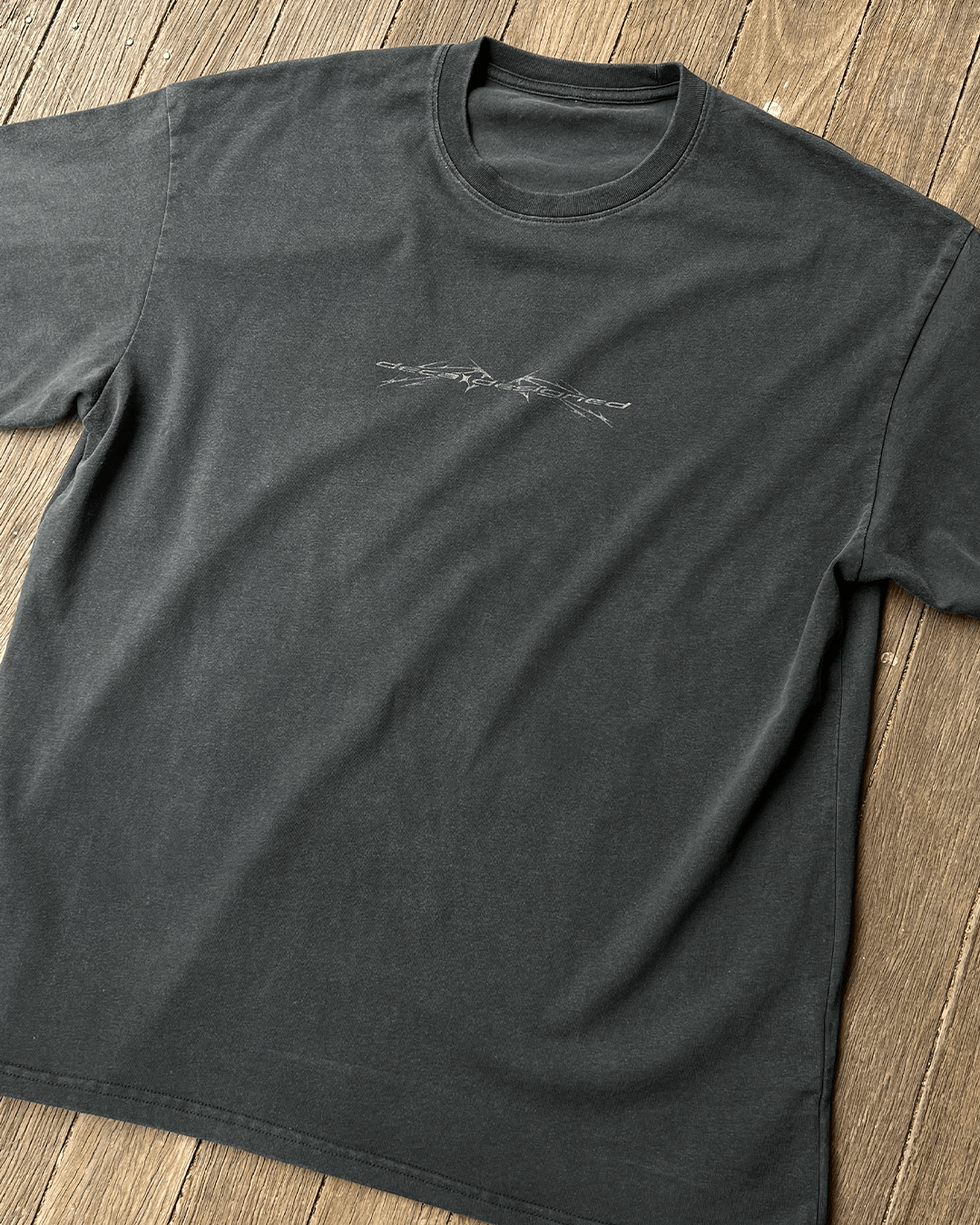 Sharp Black vintage tee with small chest print, angled front