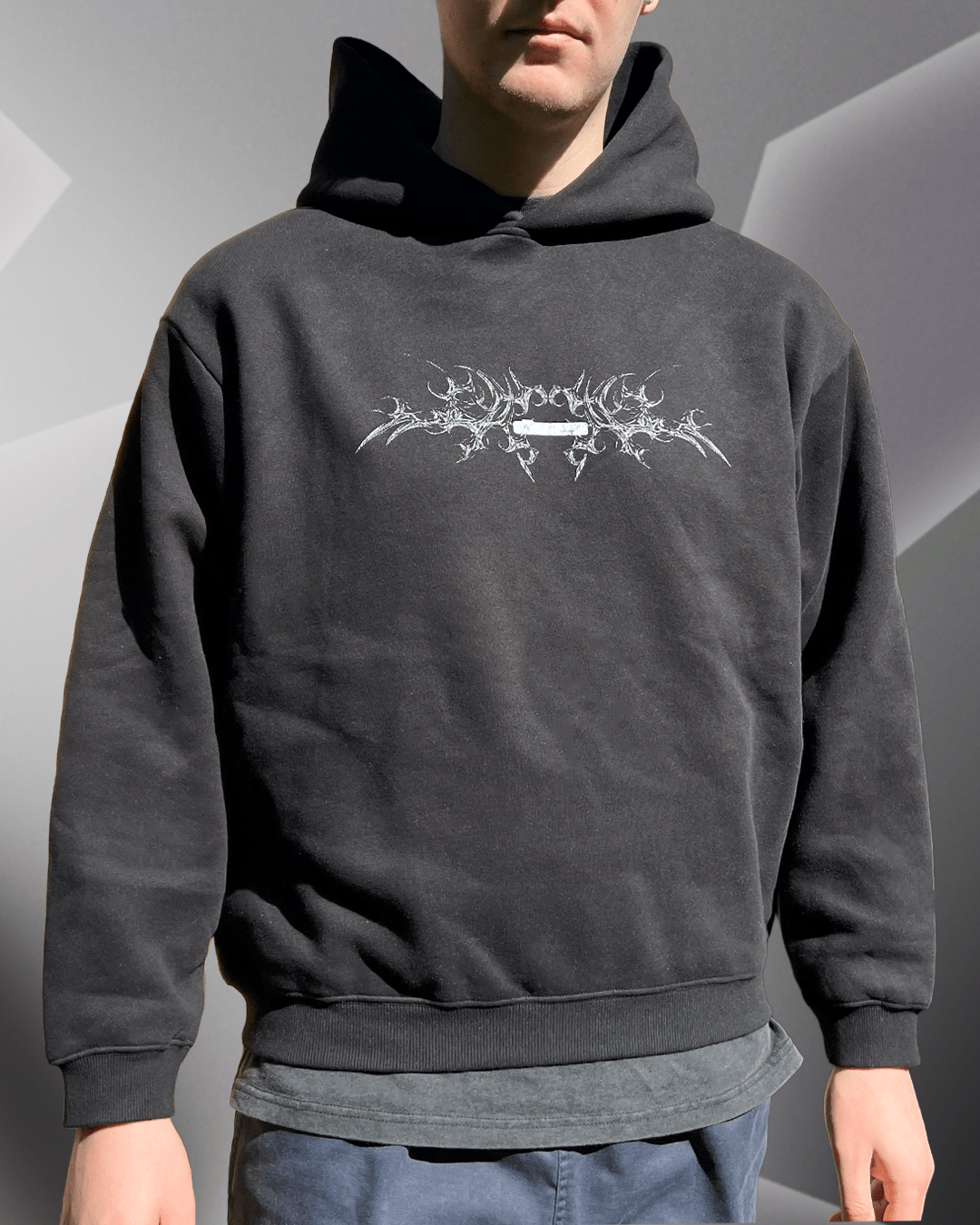 Model wearing black White Bone boxy hoodie, front view