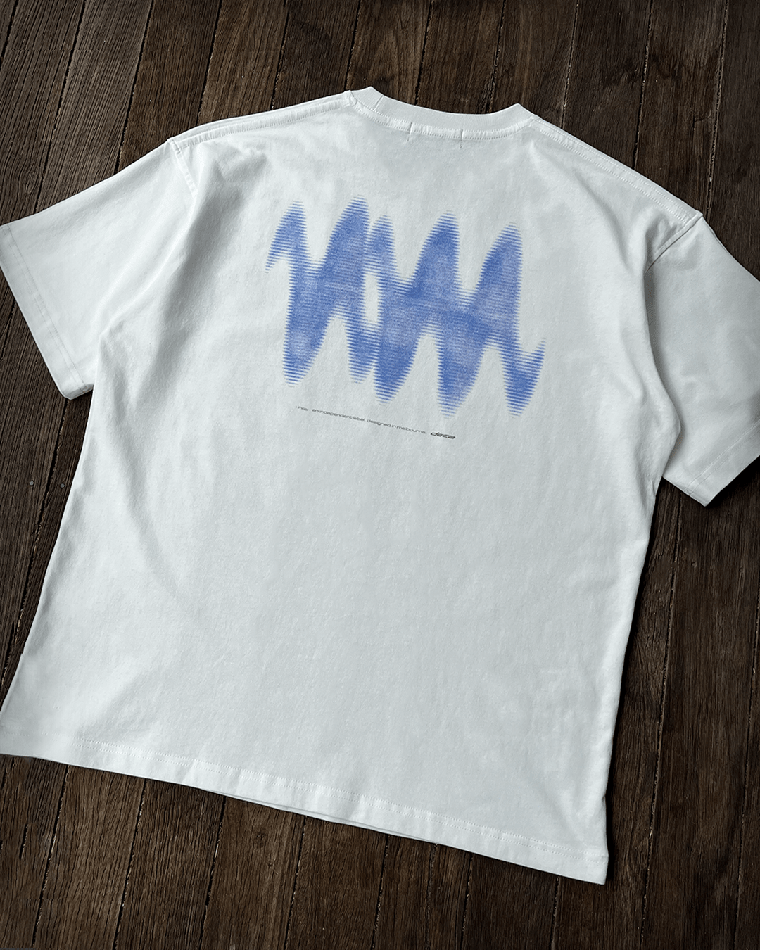 White Blue Wave vintage tee back print, angled flat lay
