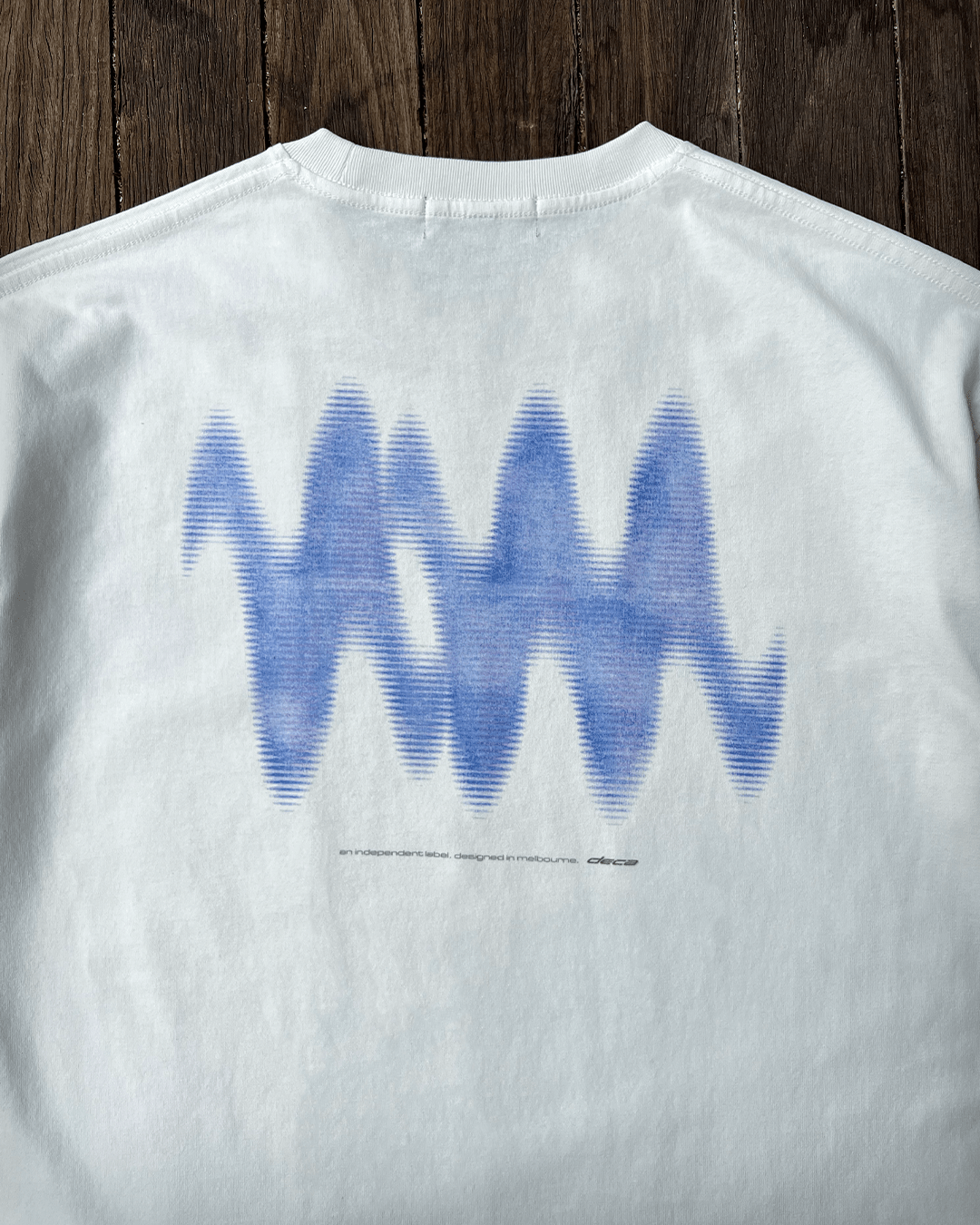 Close-up of blue wave back print on white vintage tee