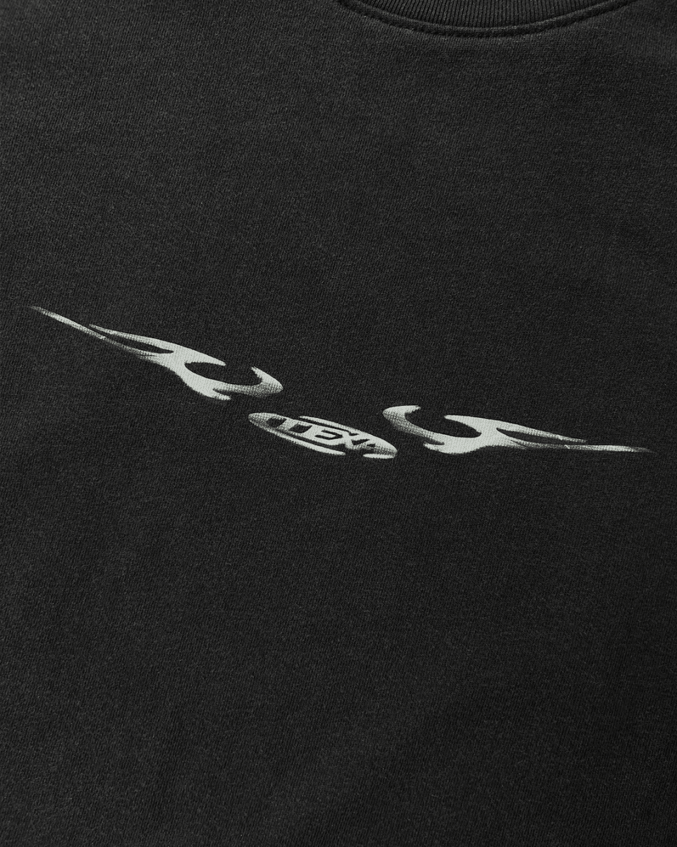 Close-up of chrome sigil wing print on black vintage tee