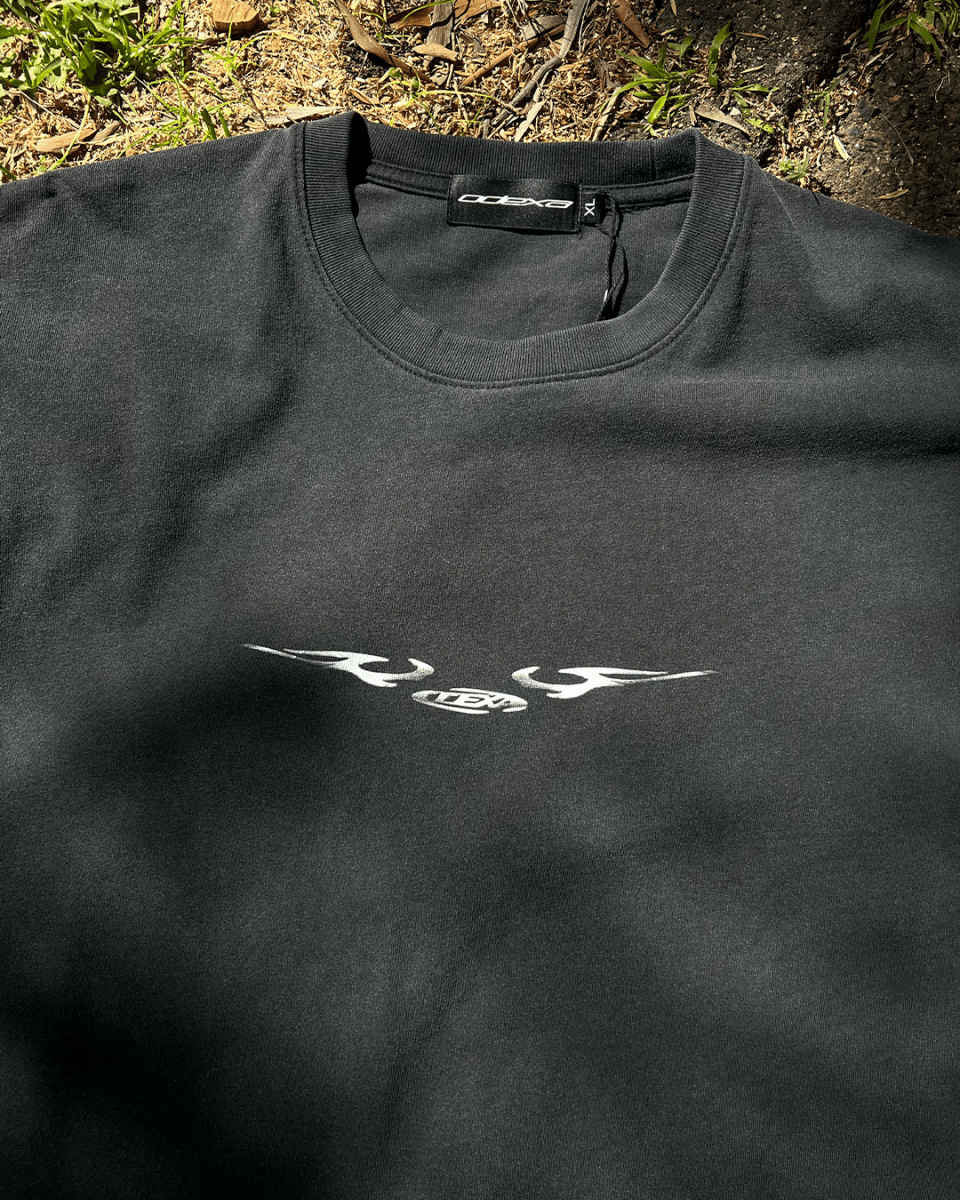 Washed black vintage tee with chrome sigil wing print, flat lay
