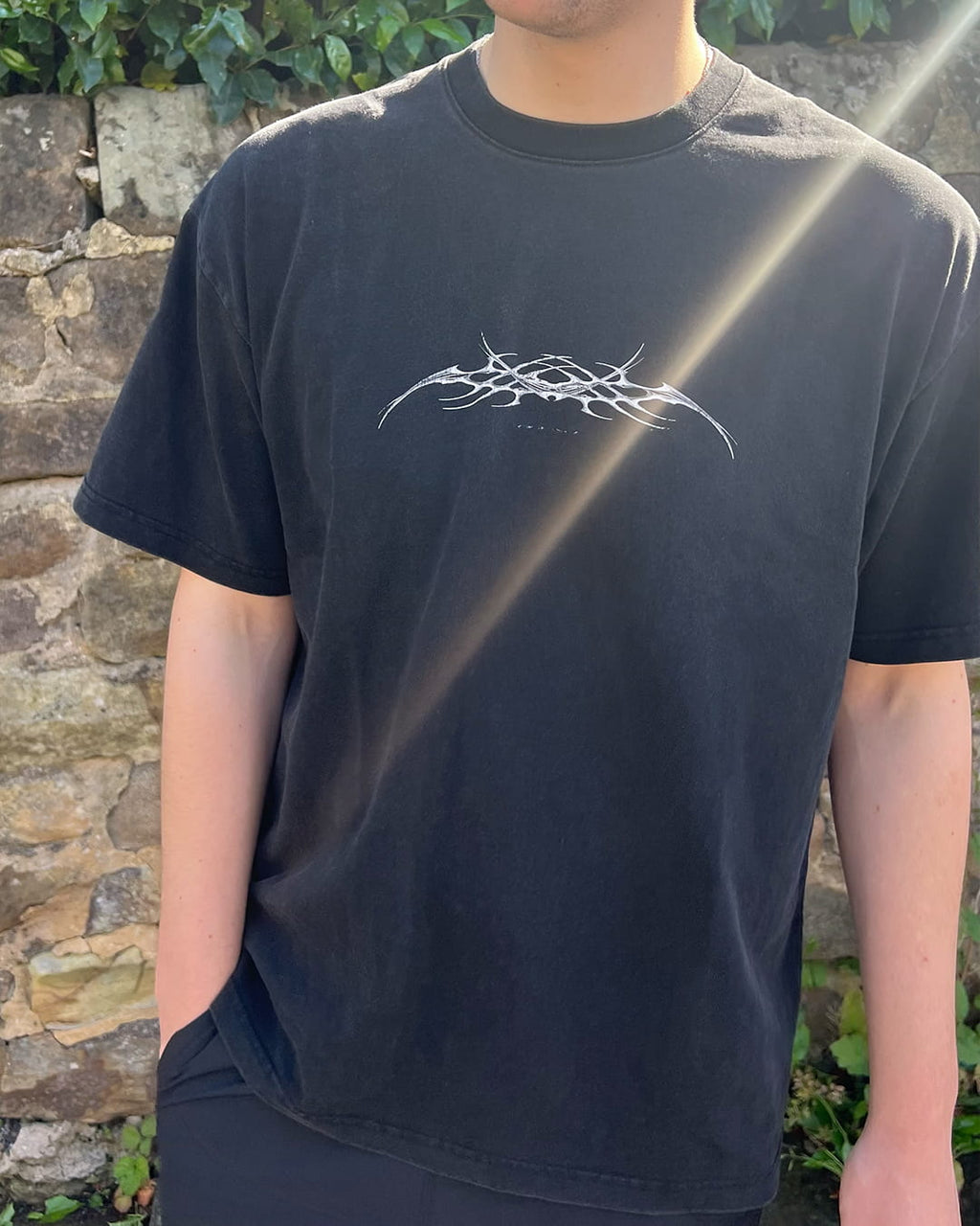 Model wearing washed black Chrome Sigil Black vintage tee