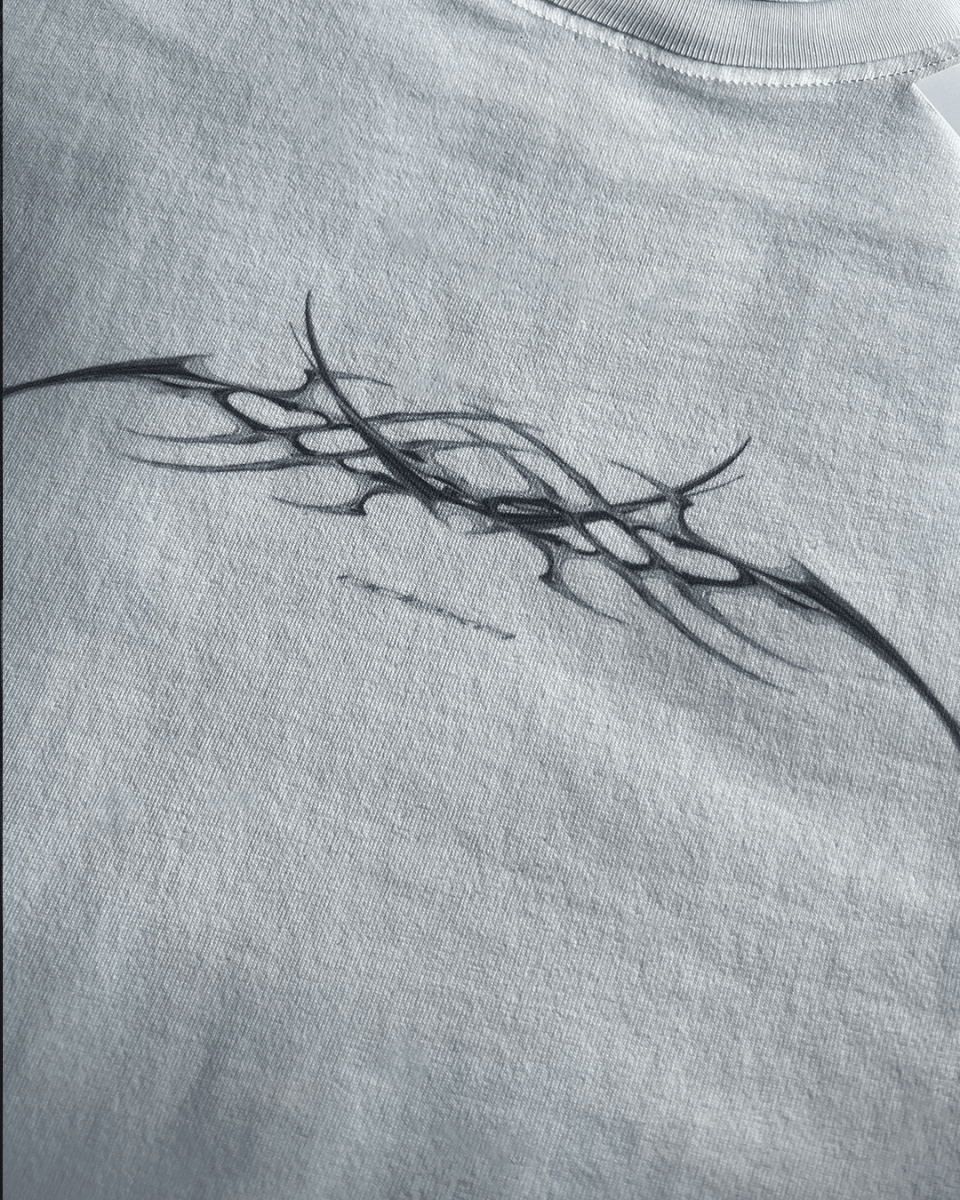 Close-up of black tribal sigil print on white vintage tee