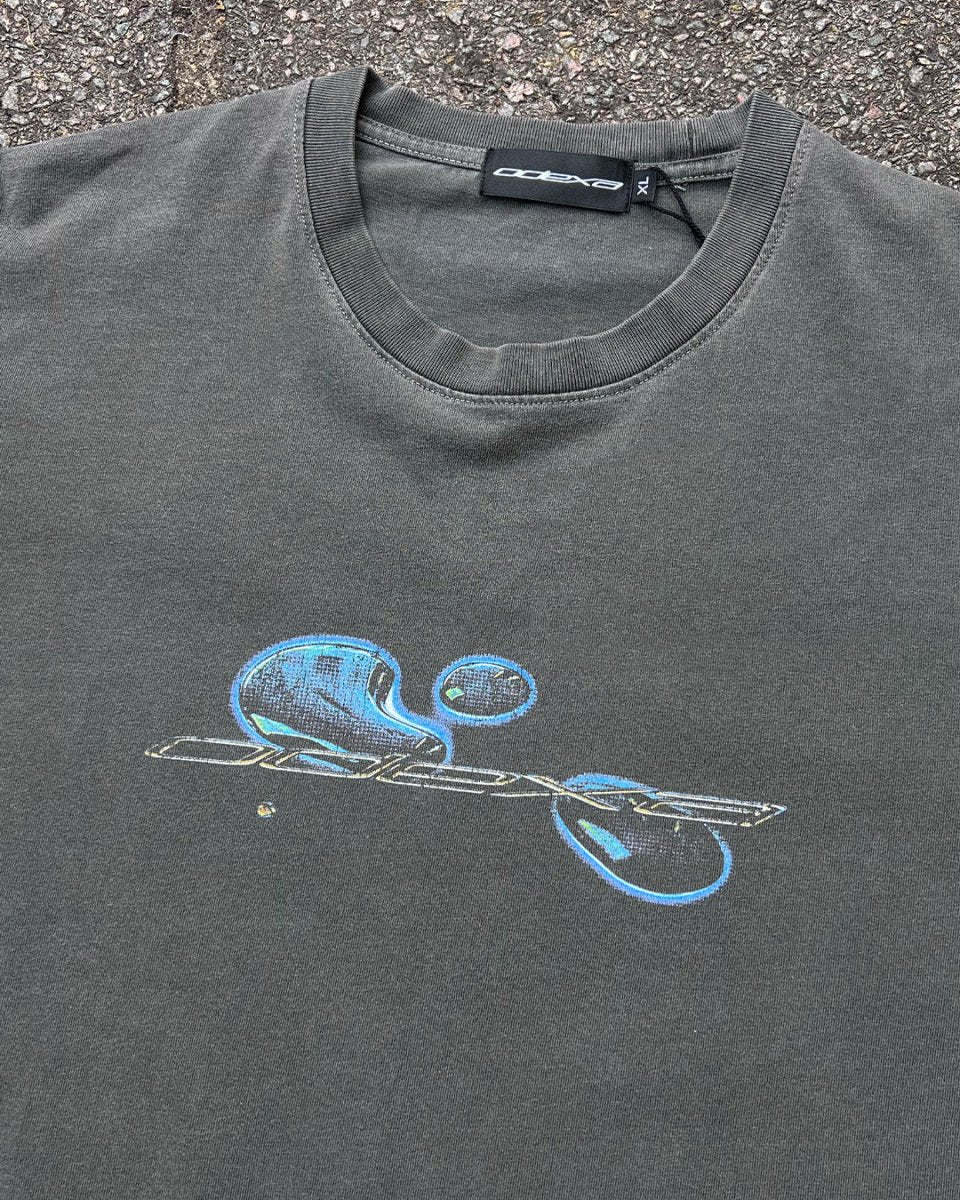 Washed grey vintage tee with blue liquid comic ODEXA logo, flat lay