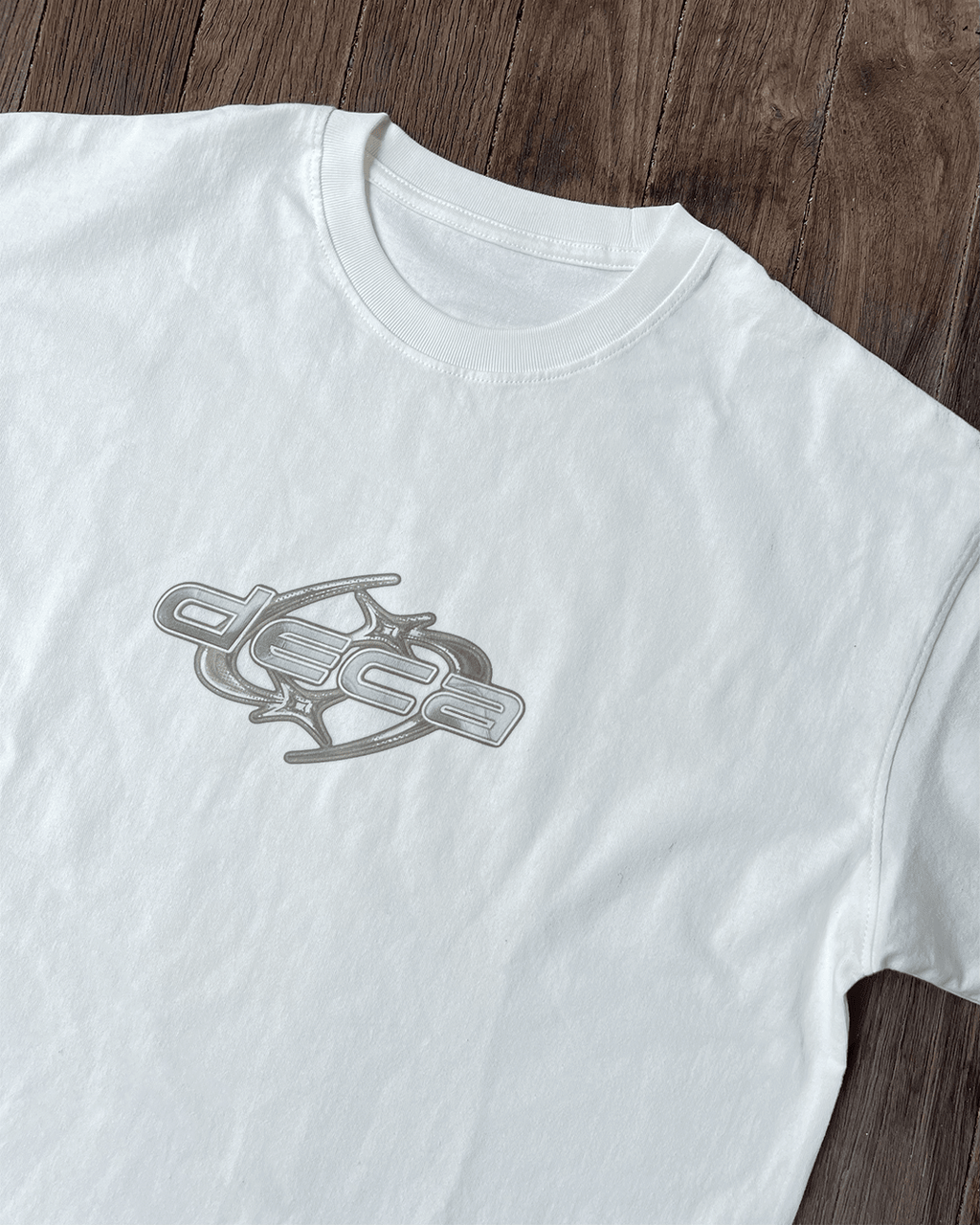 White vintage tee with grey chrome star logo print, flat lay