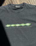 Washed black vintage tee with green digital ODEXA logo print, front view