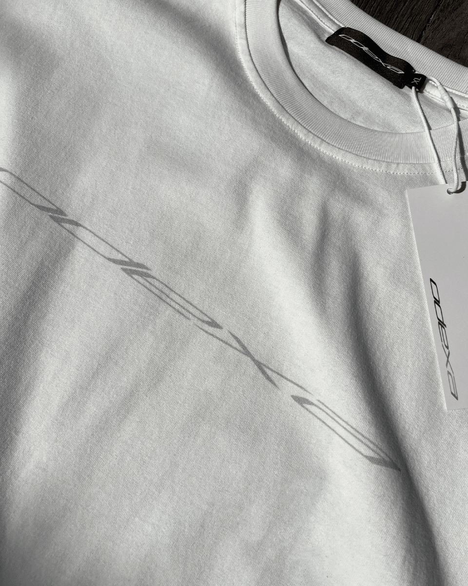 Close-up of grey diagonal logo print on white vintage tee