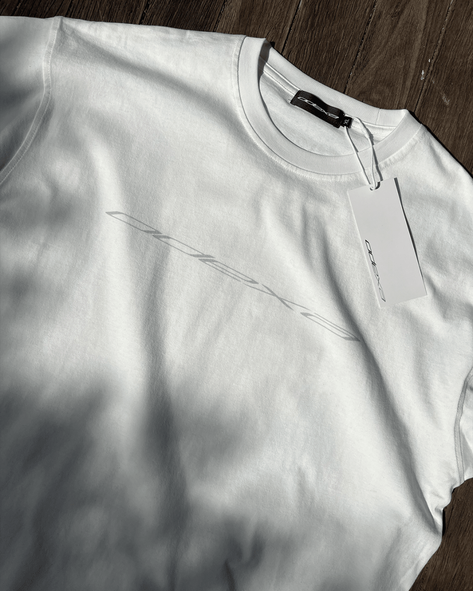 White vintage tee with subtle grey diagonal logo print, flat lay