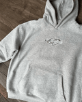 Heather grey oversized hoodie with white star logo chest print, flat lay