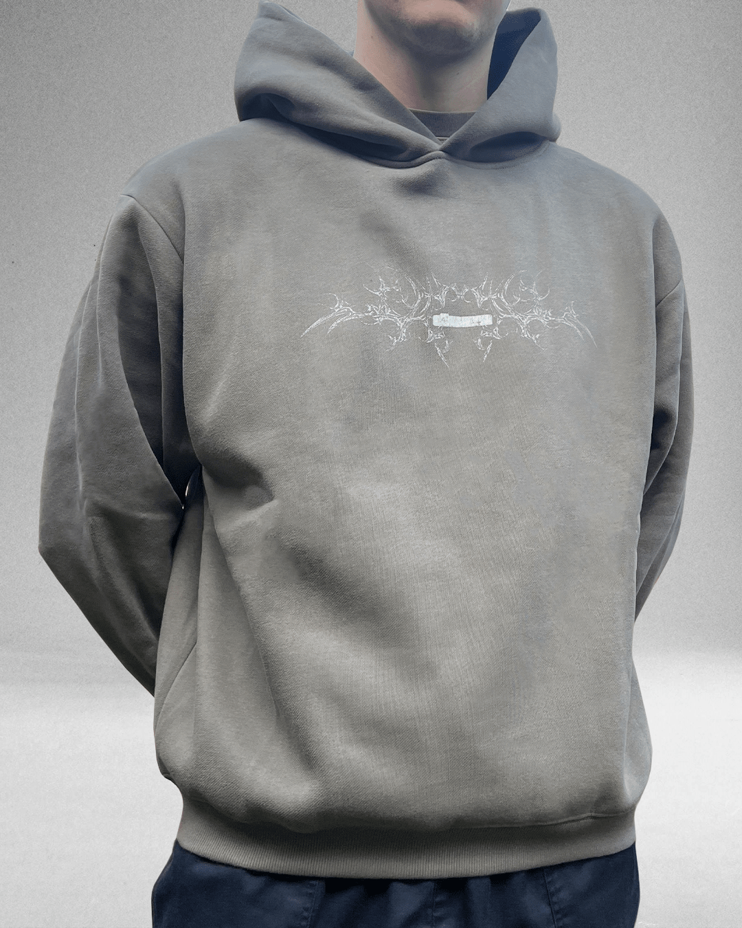Model wearing moss grey White Bone hoodie, front view