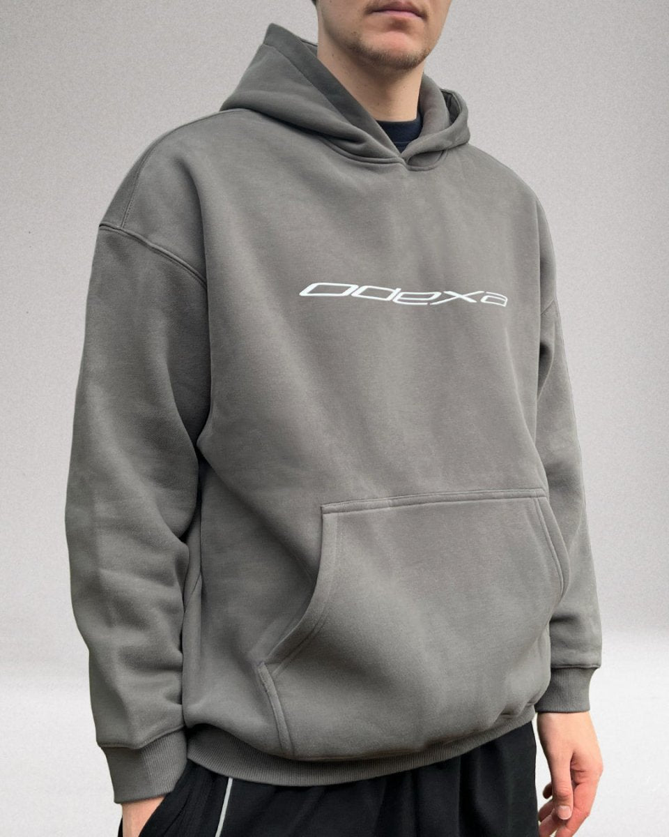 Model wearing grey ODEXA logo oversized fleeced hoodie