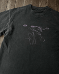 Washed black vintage tee with tonal grunge planet print, flat lay