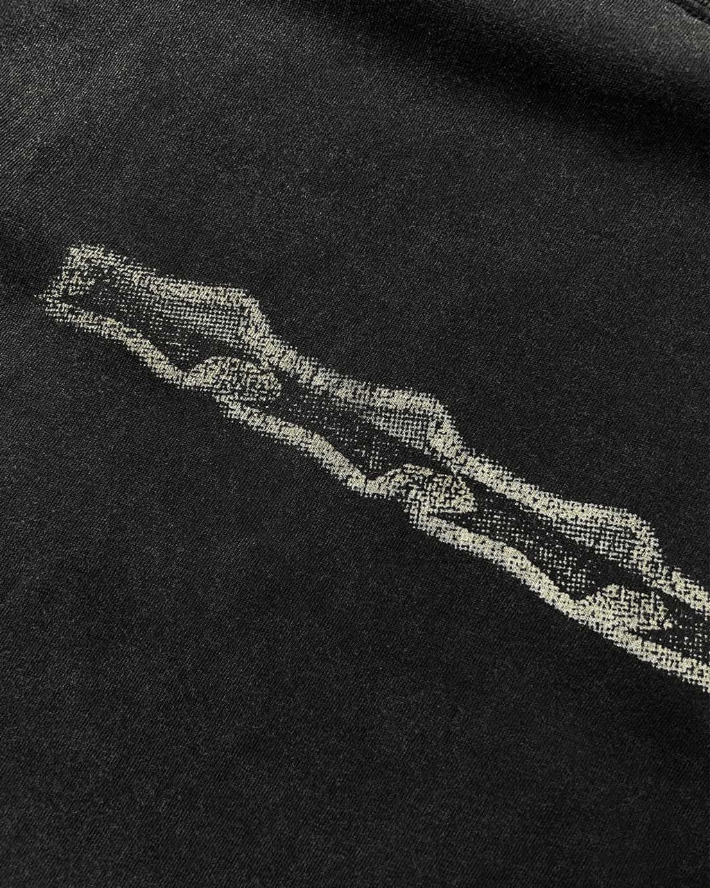 Close-up of grunge stars chest print on washed black vintage tee