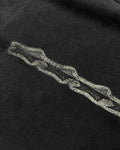 Close-up of grunge stars chest print on washed black vintage tee