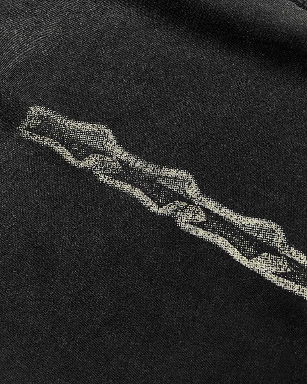 Close-up of grunge stars chest print on washed black vintage tee