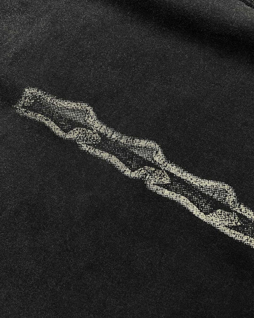 Close-up of grunge stars chest print on washed black vintage tee
