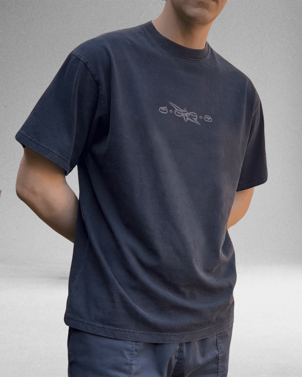 Model wearing washed navy Grunge Logo vintage tee with small chest logo