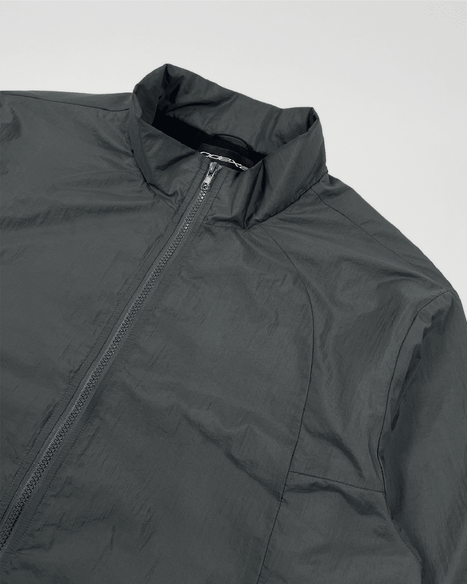 Slate green windbreaker jacket with stand collar, angled view