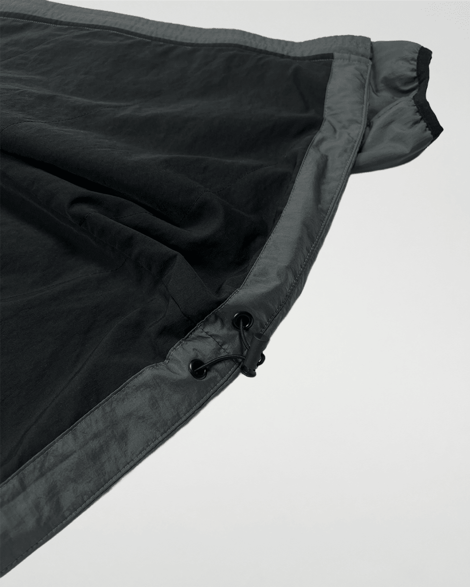 Close-up of slate green windbreaker black inner lining