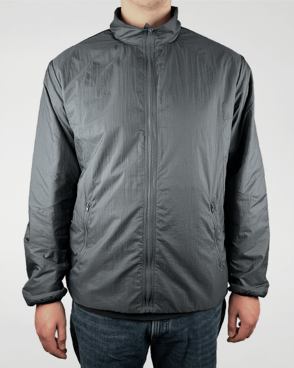 Model wearing slate green lined windbreaker jacket, front view