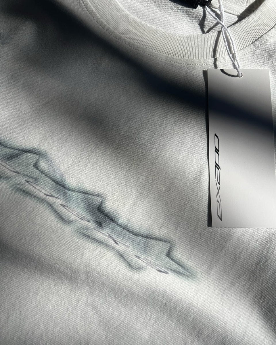 Close-up of light blue chrome logo stars print on white vintage tee