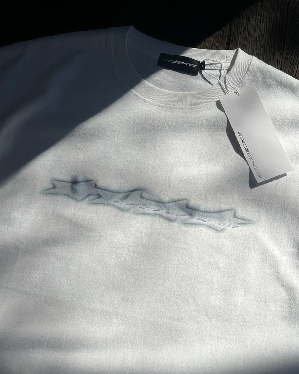 White vintage tee with blue chrome logo stars print, flat lay
