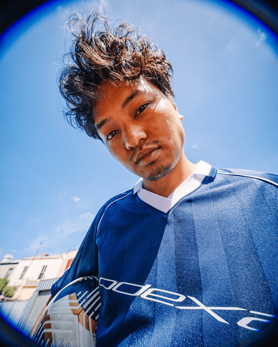 Person wearing navy ODEXA 1 jersey, fisheye close-up