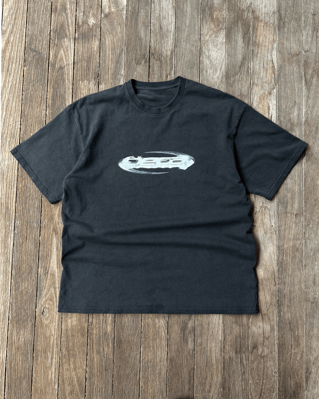 Washed black vintage tee with chrome oval Opal logo, flat lay