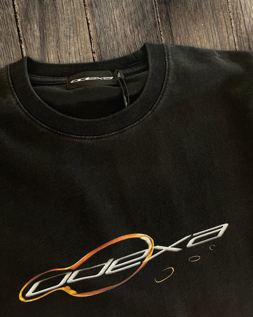 Black vintage tee with orange chrome ring ODEXA logo, flat lay