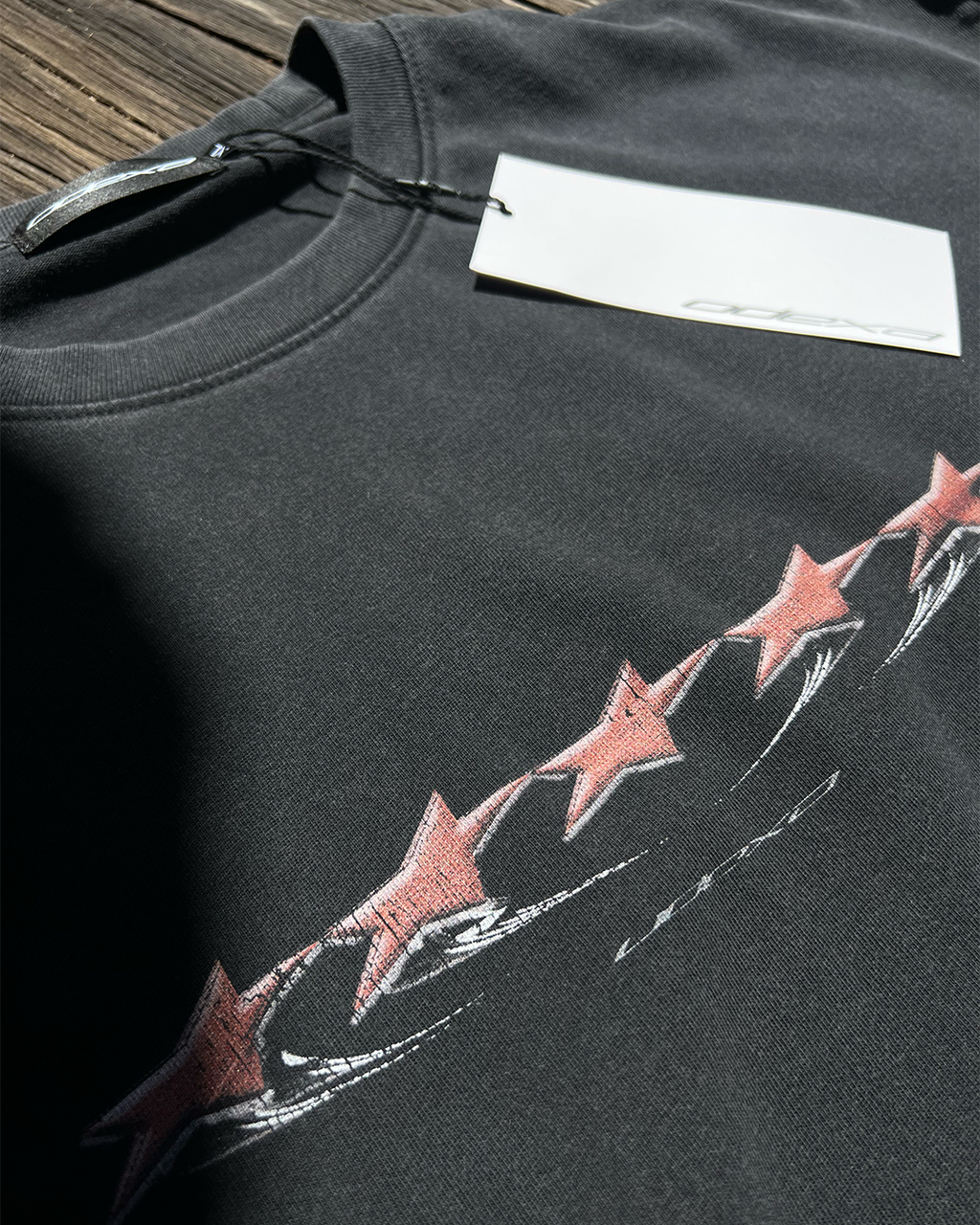 Washed black Red Stars vintage tee with red stars print, angled view