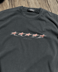 Washed black vintage tee with red stars chest print, front view