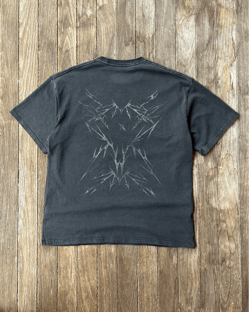 Washed black vintage tee with tribal Sharp back print, flat lay
