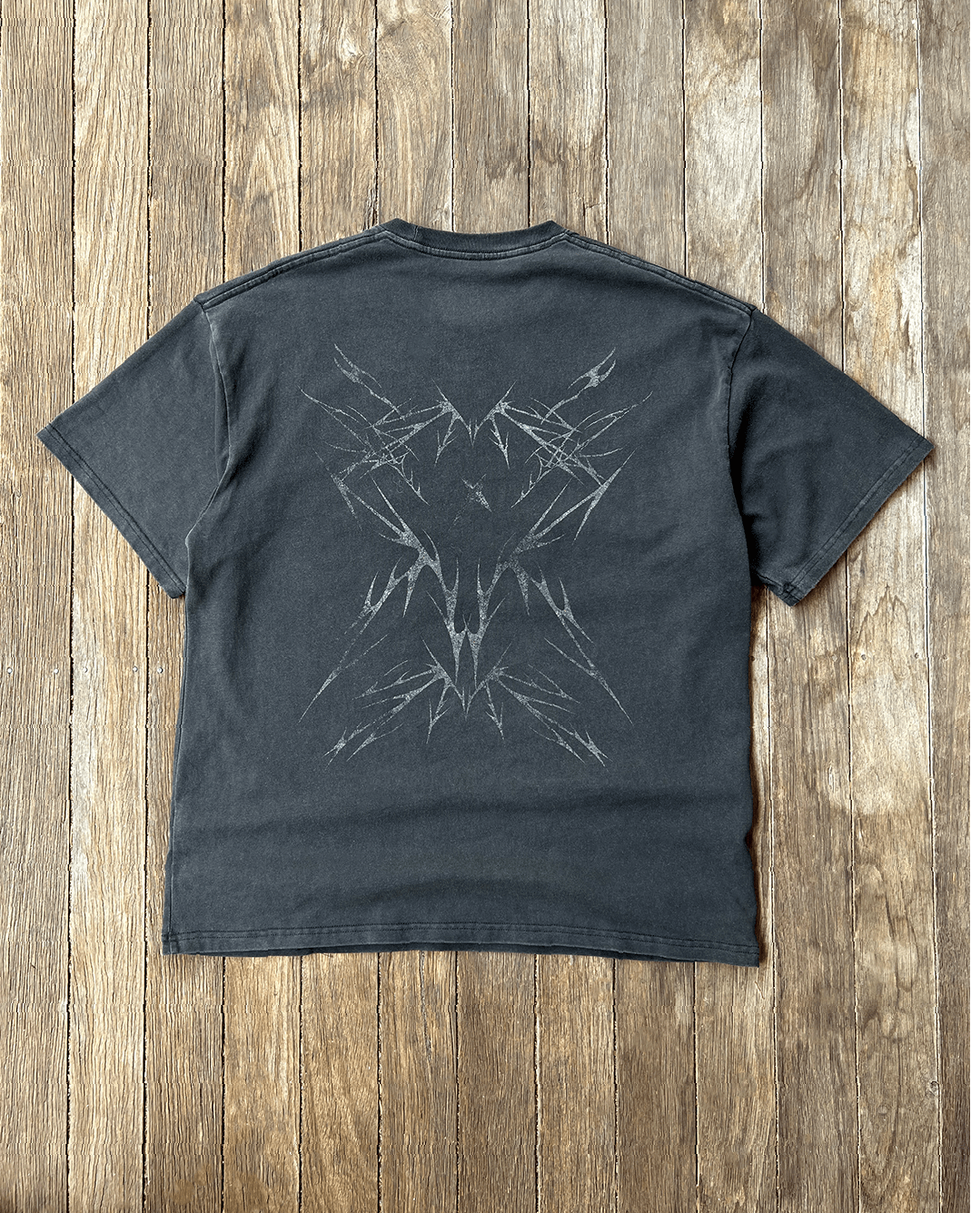 Washed black vintage tee with tribal Sharp back print, flat lay