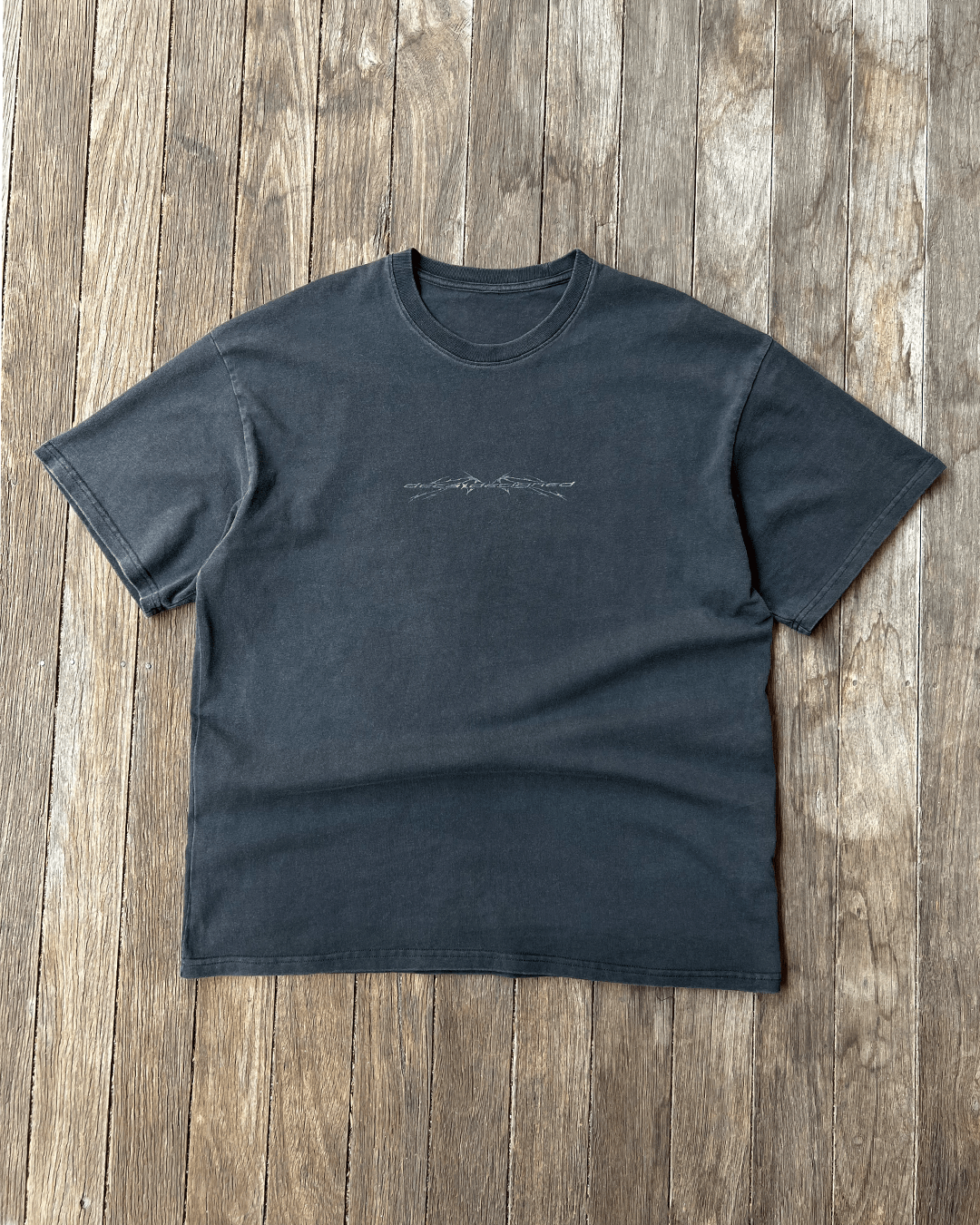 Washed black Sharp Black vintage tee with small chest print, front flat lay