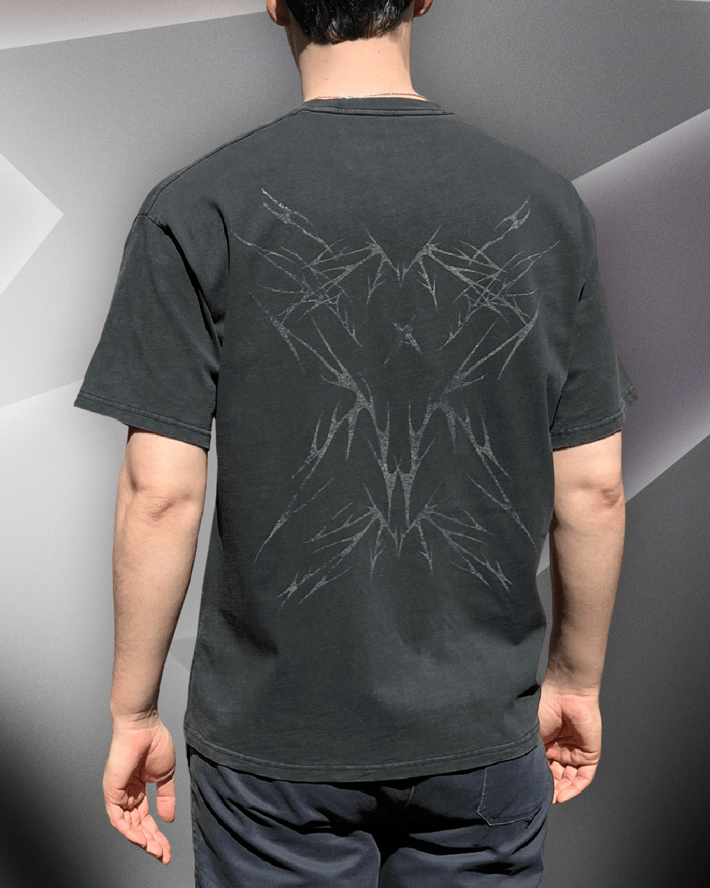 Model wearing Sharp Black vintage tee, back view showing tribal back print