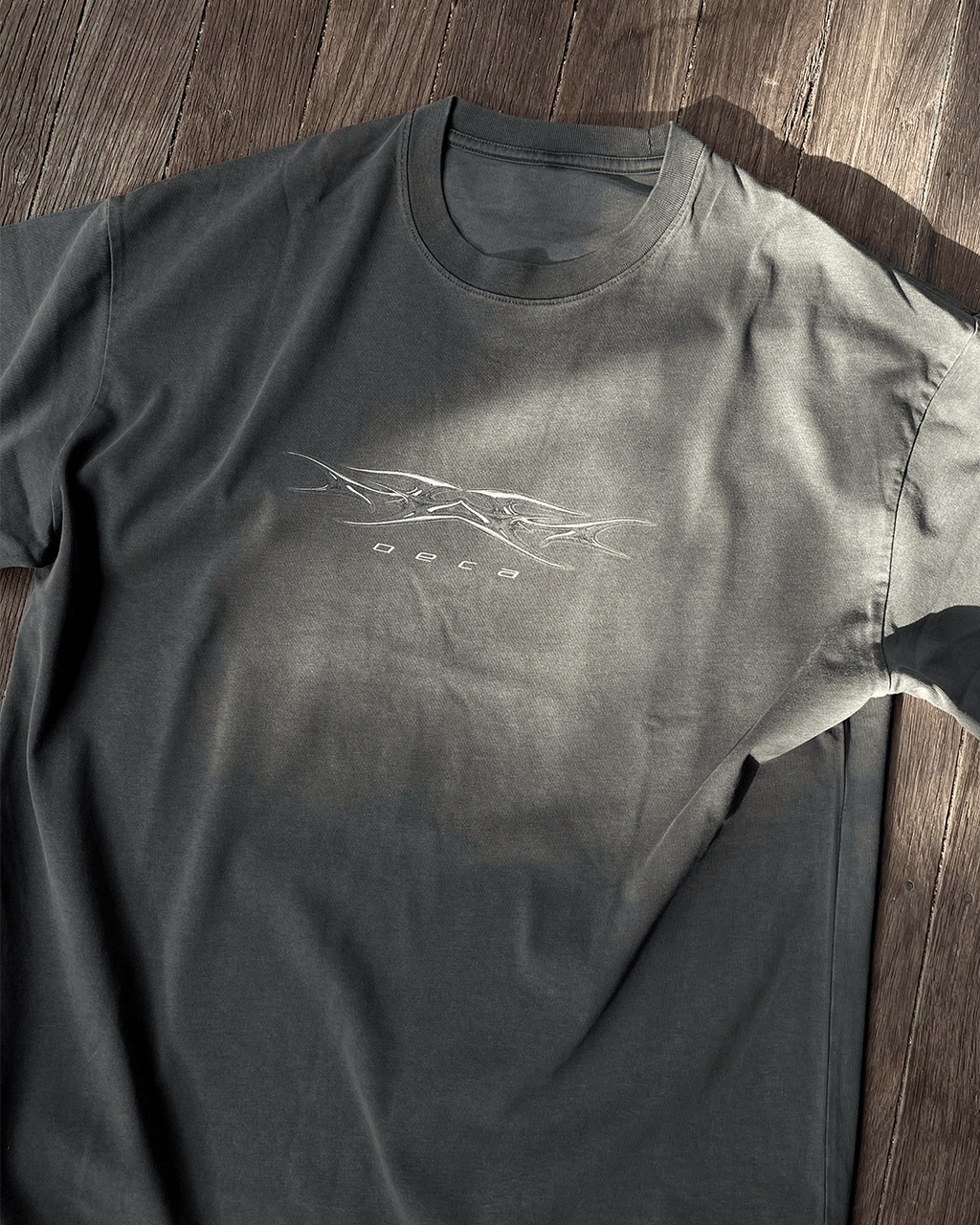 Washed grey Sharp Grey vintage tee in sunlight, flat lay