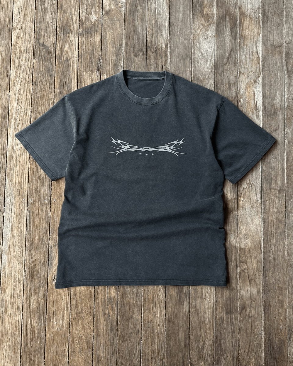 Washed black Sigil 1 vintage tee on wooden boards, flat lay