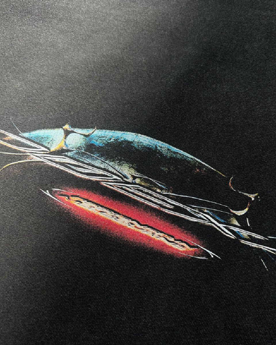 Close-up of chrome spaceship and red ODEXA logo print